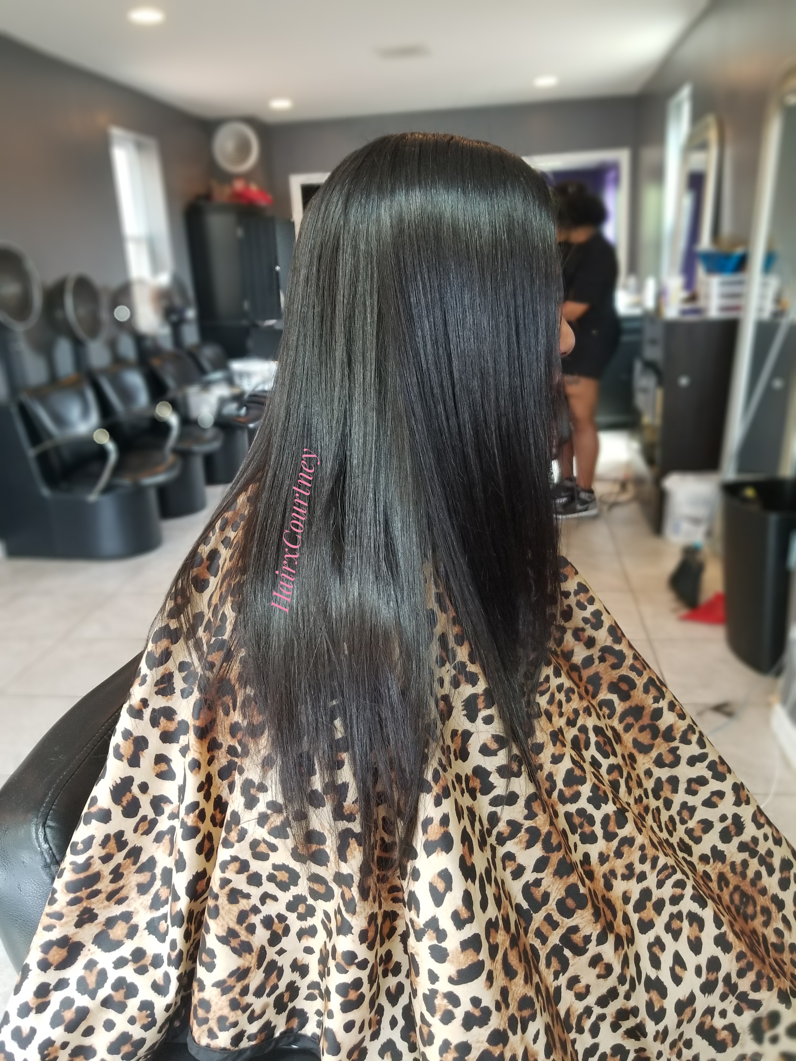 A woman getting her hair cut in a salon