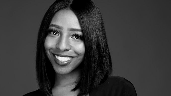 A black and white photo of a smiling woman