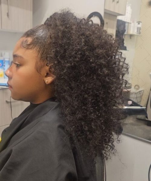 A woman getting her hair cut in a salon